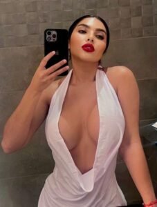 Adrianna, Amsterdam escort girl, taking a sensual selfie by the canal during a private couple escort session