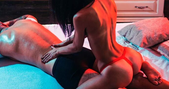 A soft-lit room with candles, a massage table, and gentle ambient glow