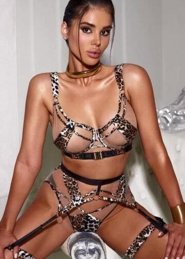 Blonde escort Paulyna lying on silk bedspread