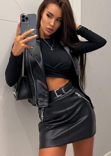 Katalyna taking a mirror selfie dressed in a black leather outfit showing her stylish attitude and dominant presence